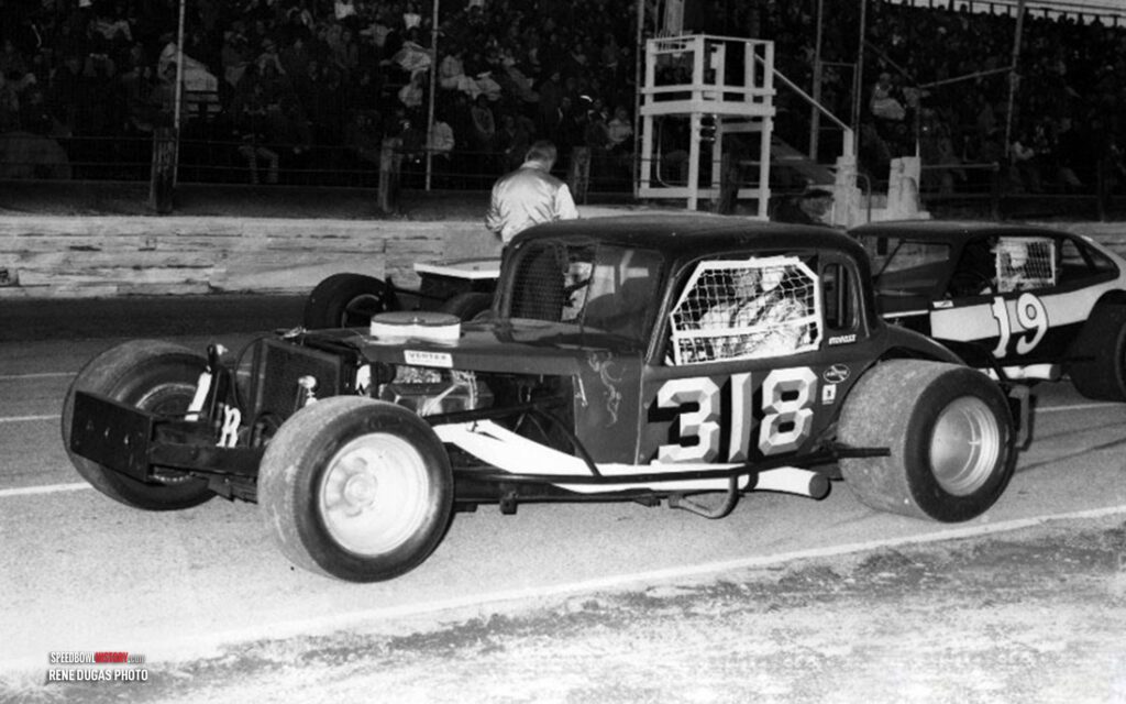 Black and white abstract pattern with concentric circles and wave shapes.