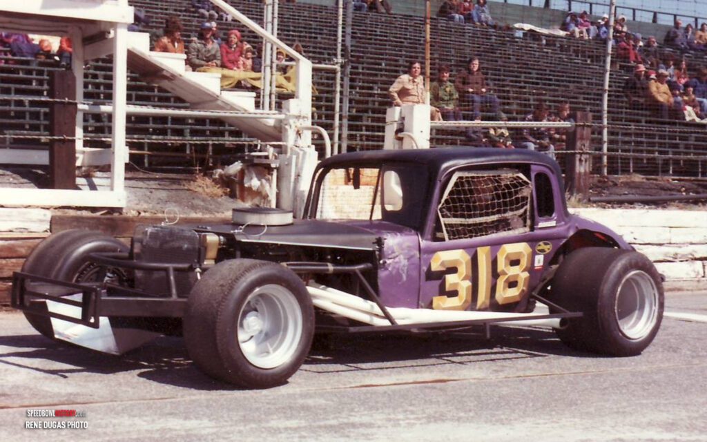 Black and white abstract pattern with concentric circles and wave shapes.