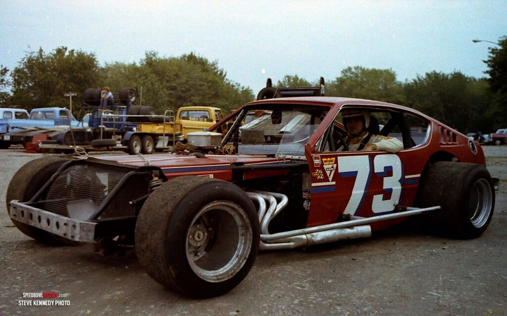 Black and white abstract pattern with concentric circles and wave shapes.