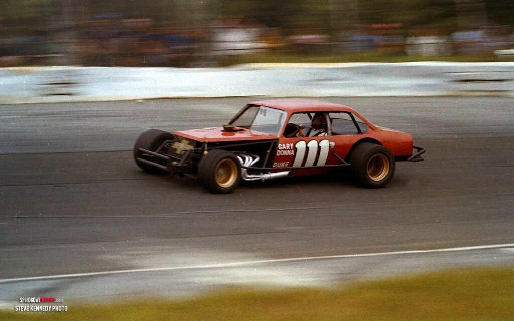 Black and white abstract pattern with concentric circles and wave shapes.