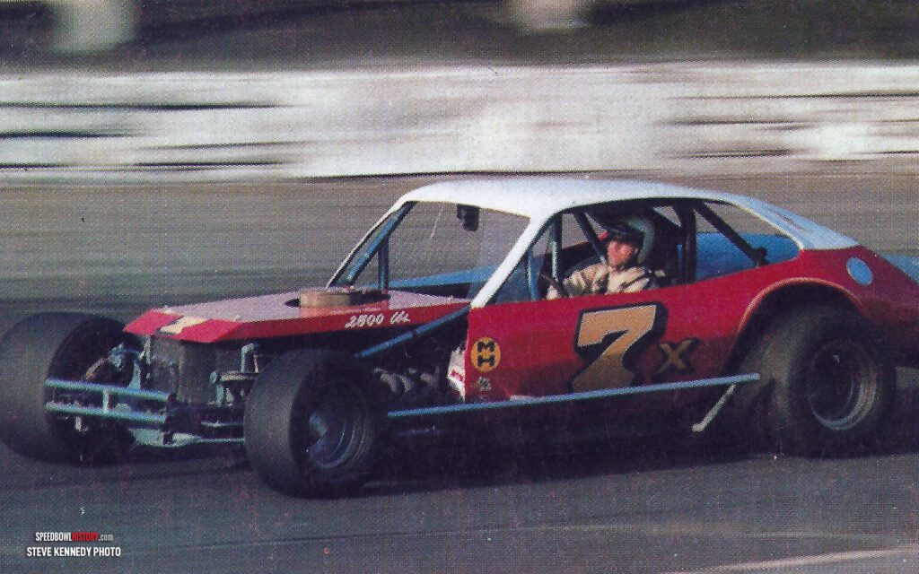 Black and white abstract pattern with concentric circles and wave shapes.