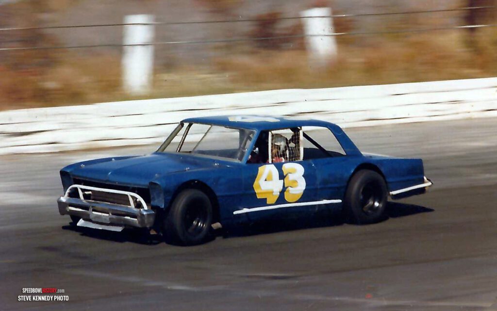 Black and white abstract pattern with concentric circles and wave shapes.