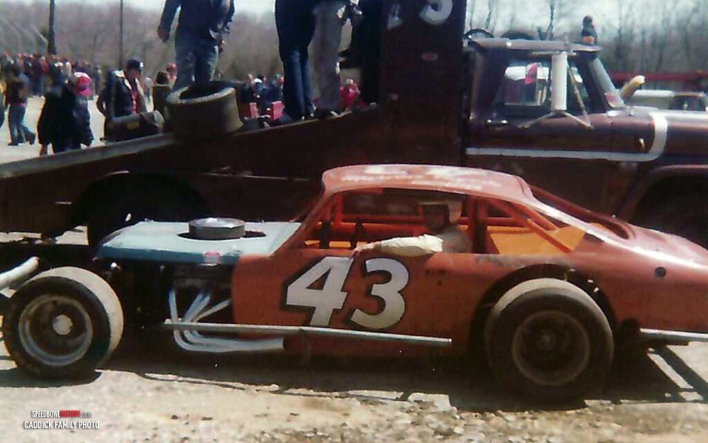 Black and white abstract pattern with concentric circles and wave shapes.