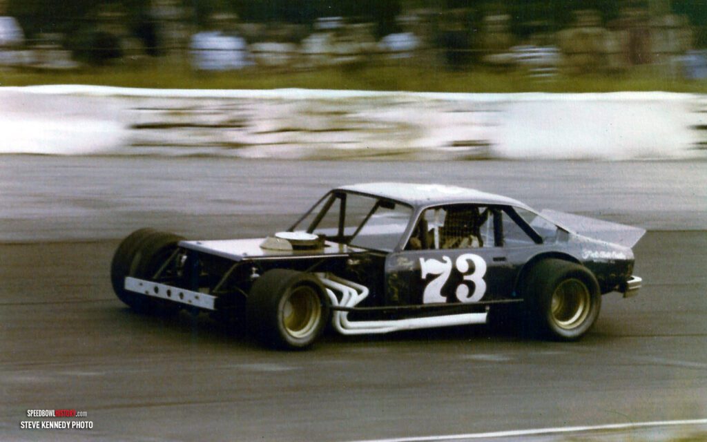 Black and white abstract pattern with concentric circles and wave shapes.