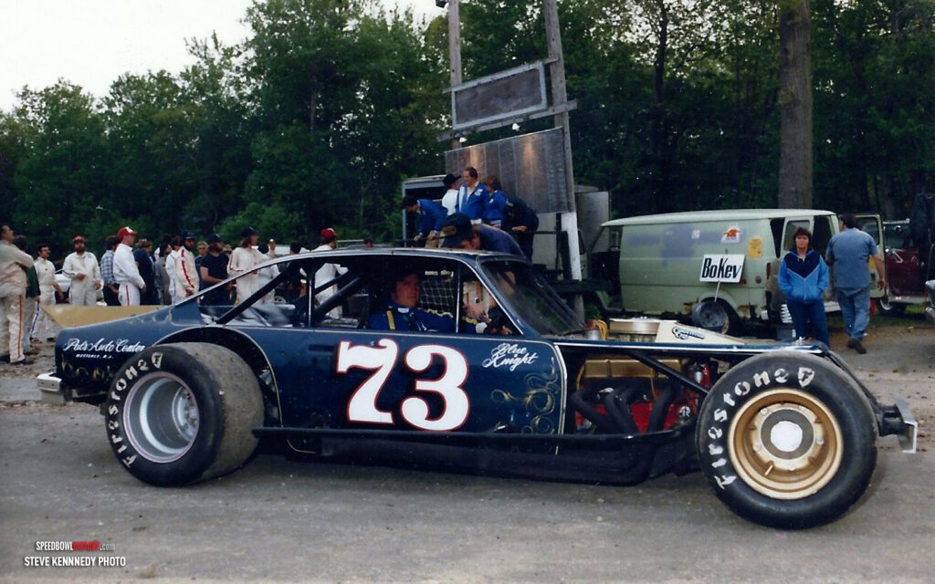 Black and white abstract pattern with concentric circles and wave shapes.