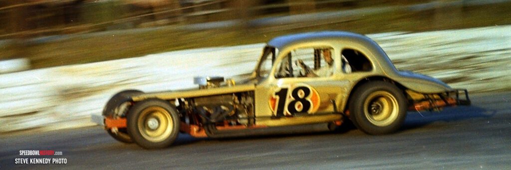 Black and white abstract pattern with concentric circles and wave shapes.