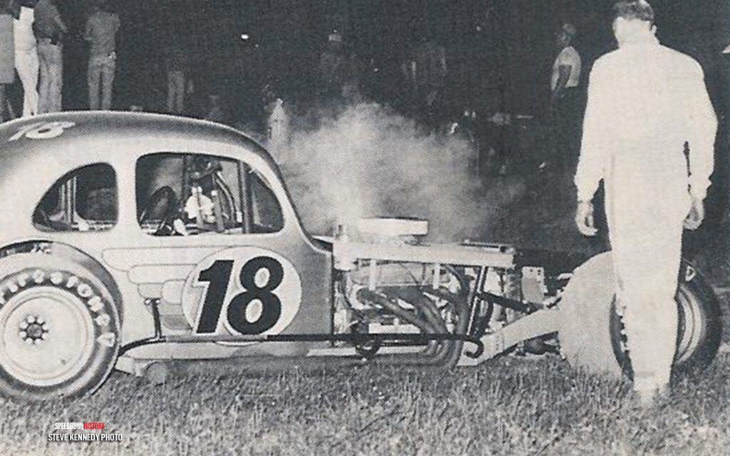 Black and white abstract pattern with concentric circles and wave shapes.