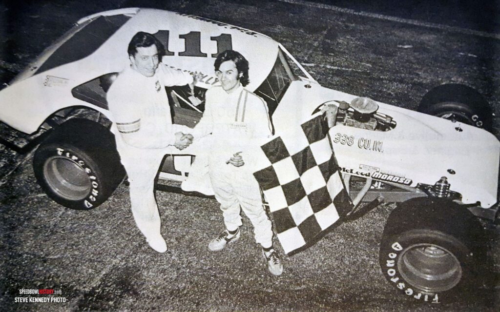 Black and white abstract pattern with concentric circles and wave shapes.