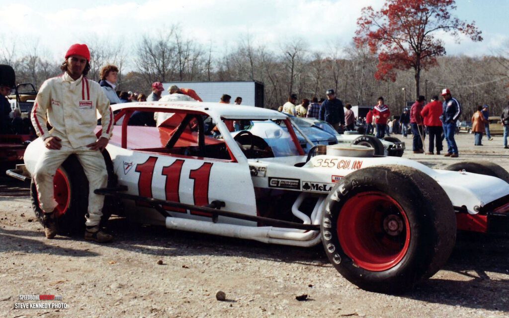 Black and white abstract pattern with concentric circles and wave shapes.