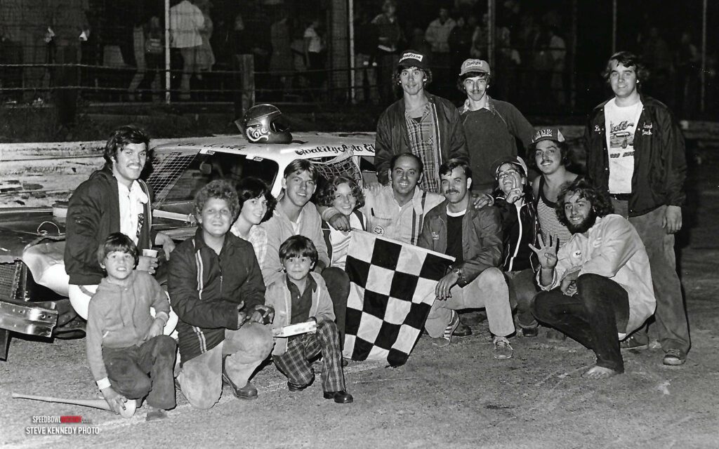 Black and white abstract pattern with concentric circles and wave shapes.