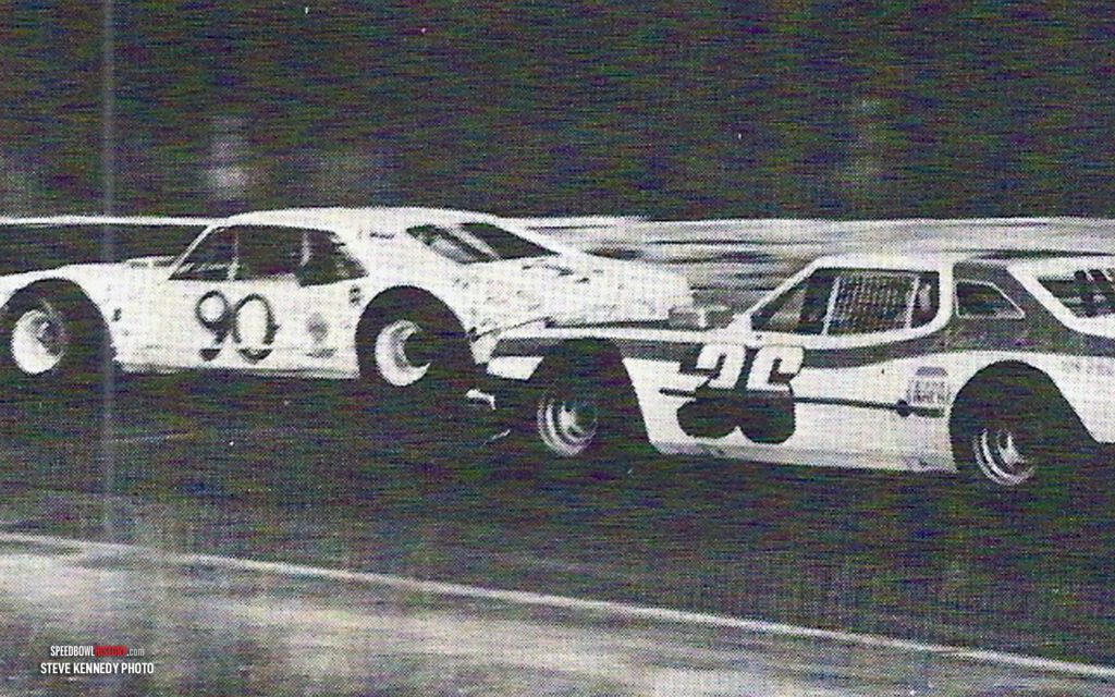 Black and white abstract pattern with concentric circles and wave shapes.