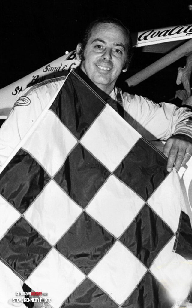 Black and white abstract pattern with concentric circles and wave shapes.