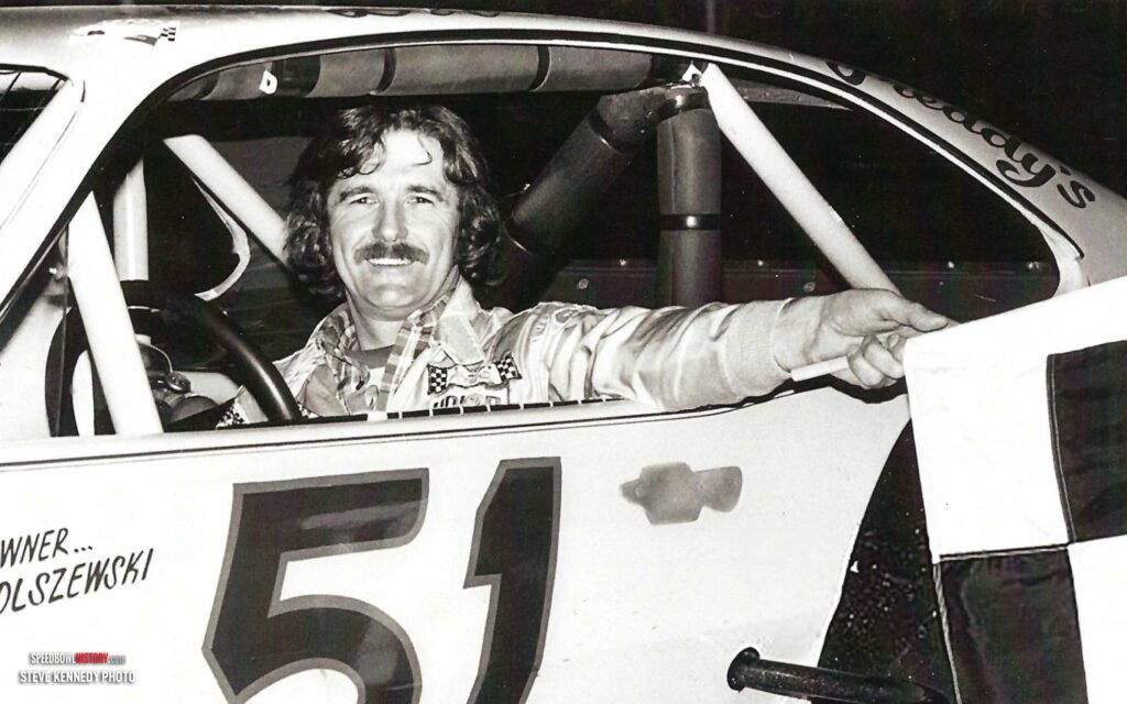 Black and white abstract pattern with concentric circles and wave shapes.