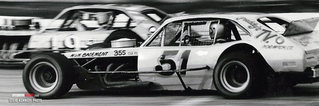 Black and white abstract pattern with concentric circles and wave shapes.