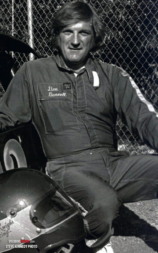 Black and white abstract pattern with concentric circles and wave shapes.