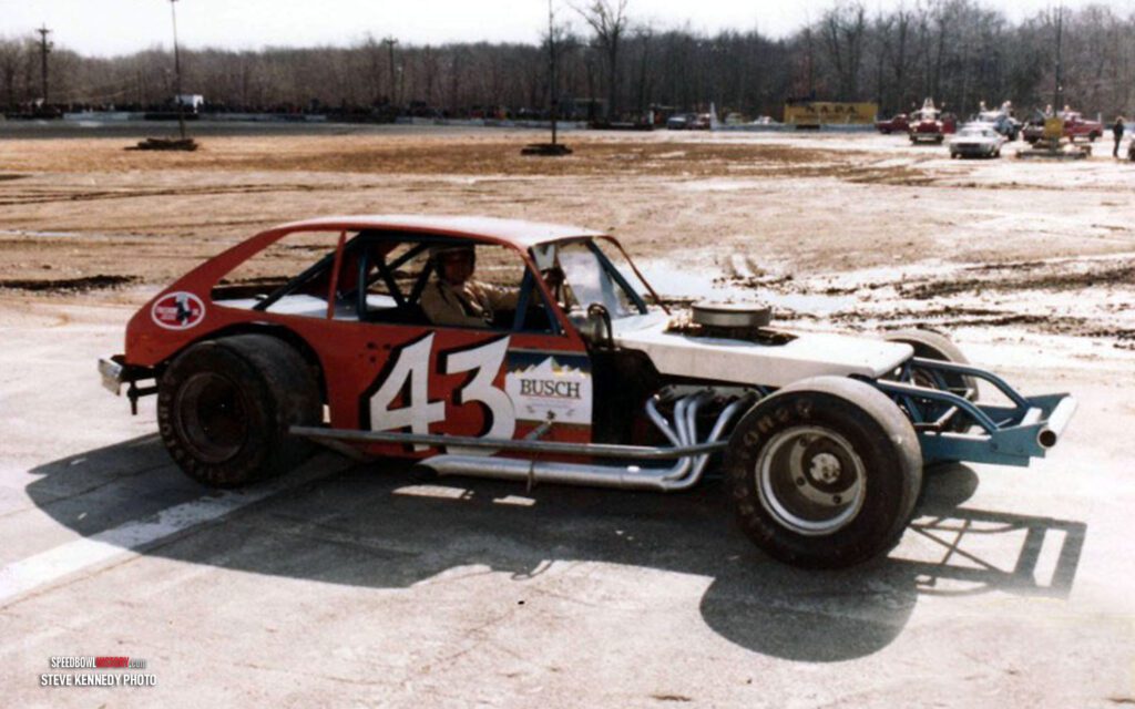 Black and white abstract pattern with concentric circles and wave shapes.
