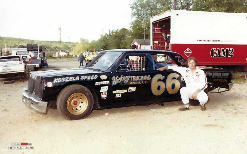 Black and white abstract pattern with concentric circles and wave shapes.