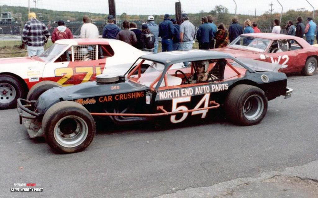 Black and white abstract pattern with concentric circles and wave shapes.