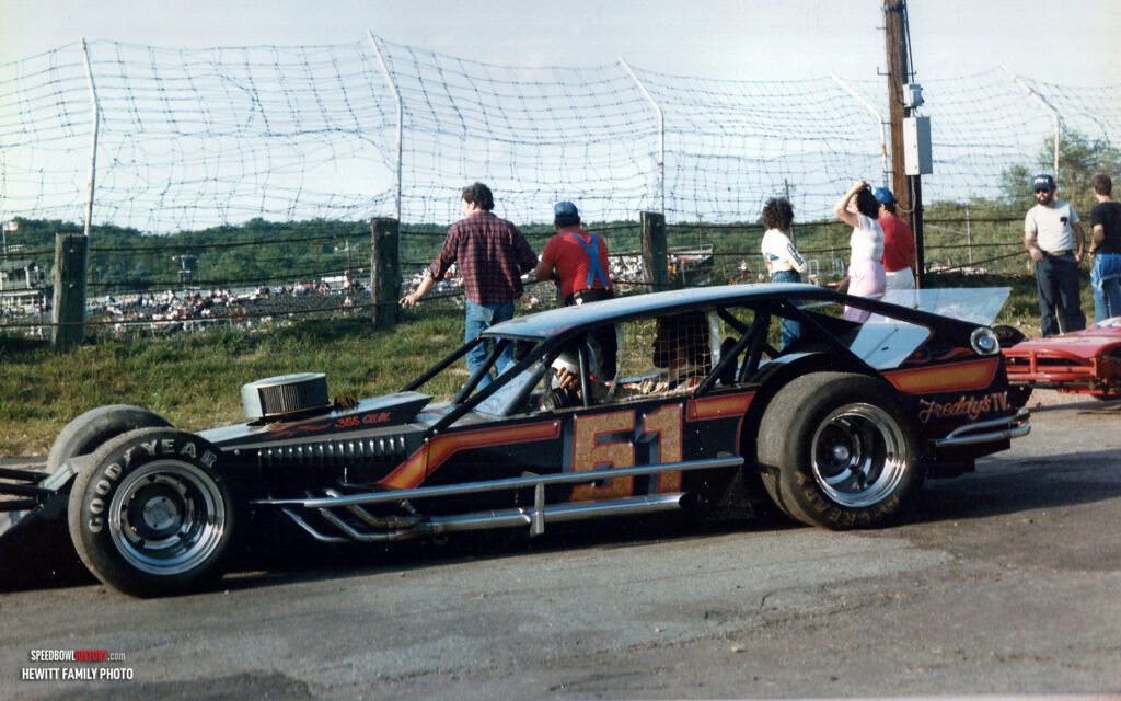 Black and white abstract pattern with concentric circles and wave shapes.