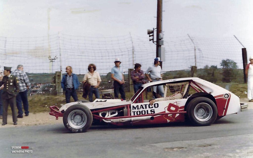 Black and white abstract pattern with concentric circles and wave shapes.