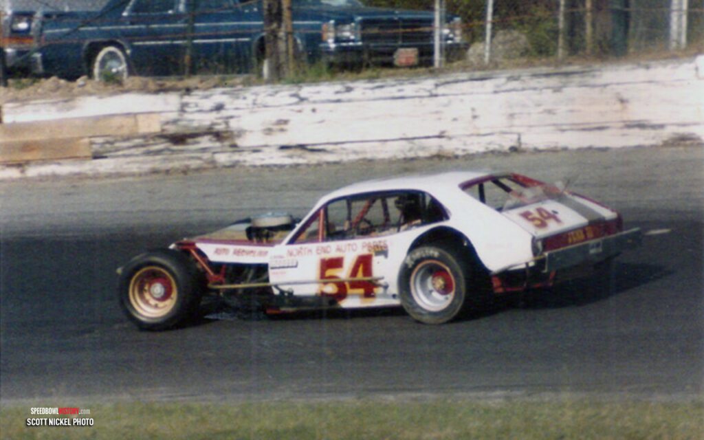 Black and white abstract pattern with concentric circles and wave shapes.