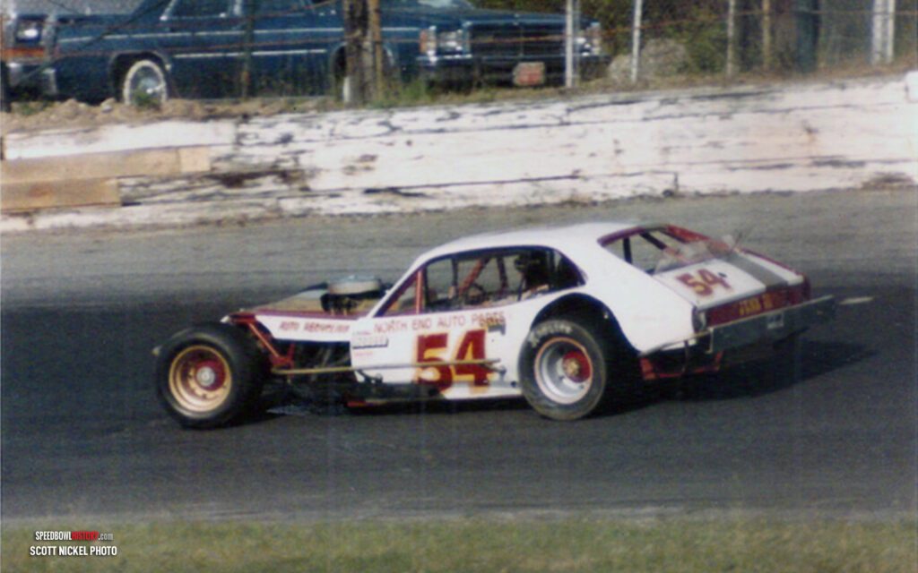 Black and white abstract pattern with concentric circles and wave shapes.