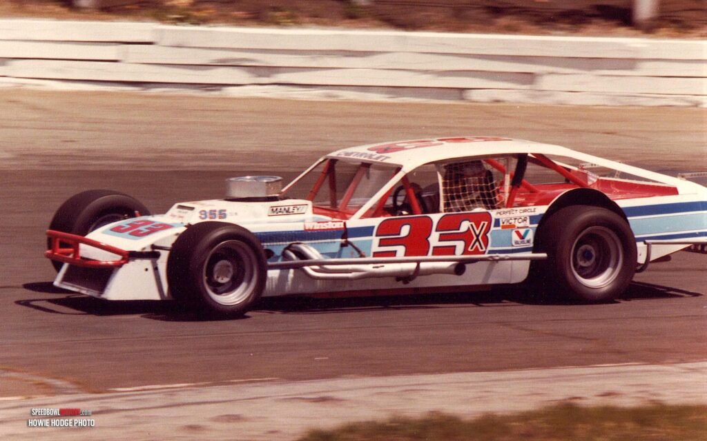 Black and white abstract pattern with concentric circles and wave shapes.