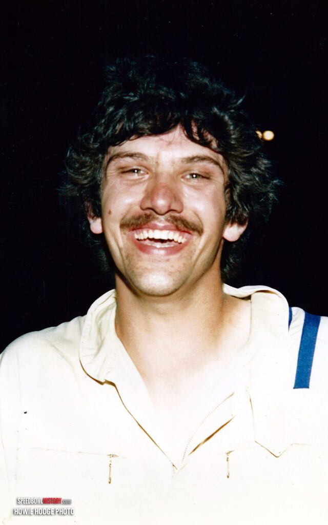 Black and white abstract pattern with concentric circles and wave shapes.