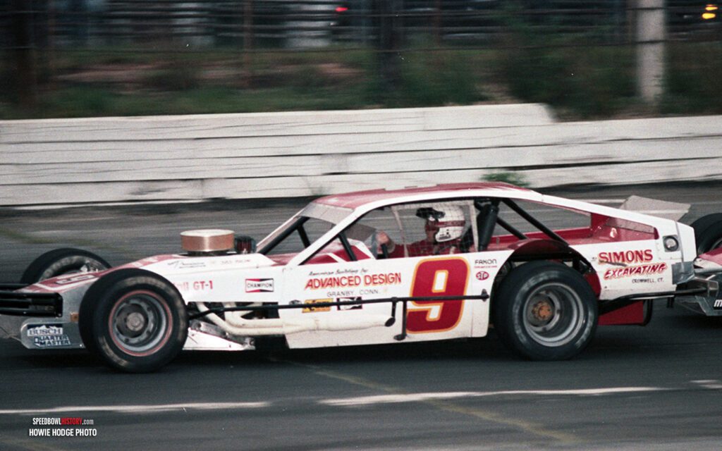 Black and white abstract pattern with concentric circles and wave shapes.