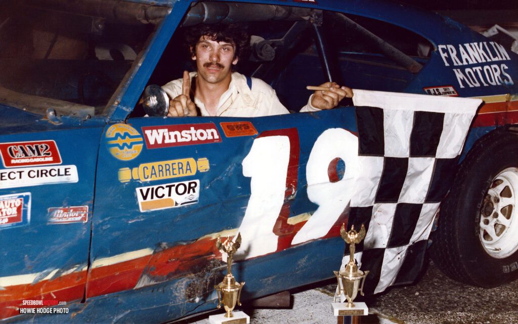 Black and white abstract pattern with concentric circles and wave shapes.