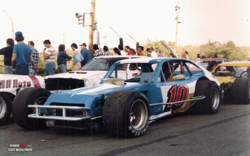 Black and white abstract pattern with concentric circles and wave shapes.