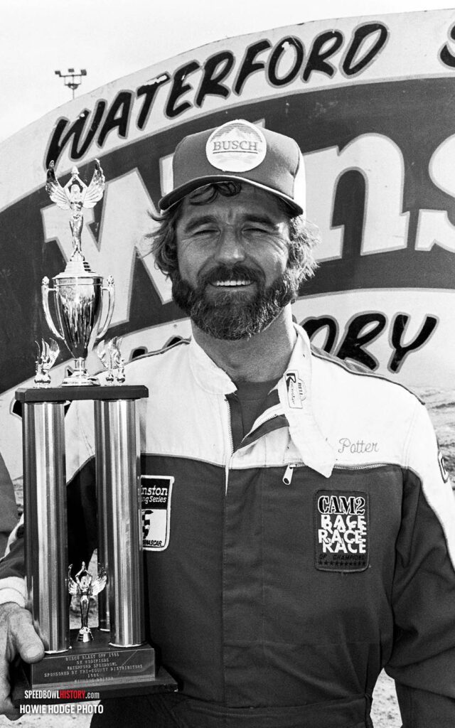 Black and white abstract pattern with concentric circles and wave shapes.