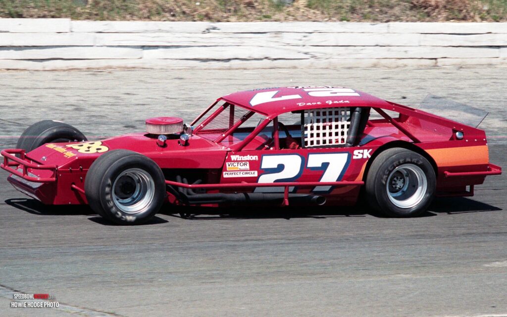 Black and white abstract pattern with concentric circles and wave shapes.