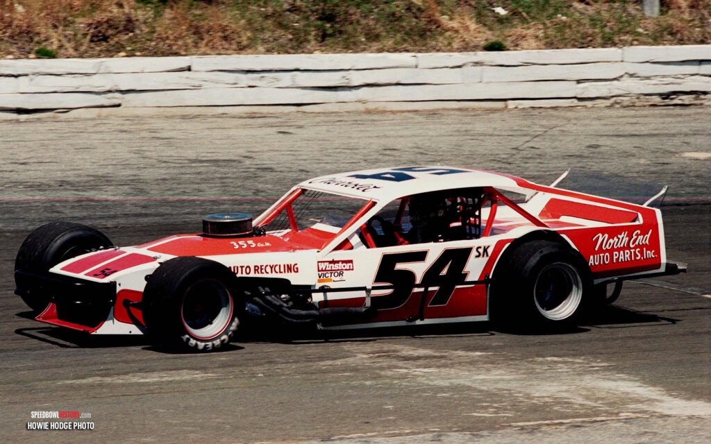 Black and white abstract pattern with concentric circles and wave shapes.