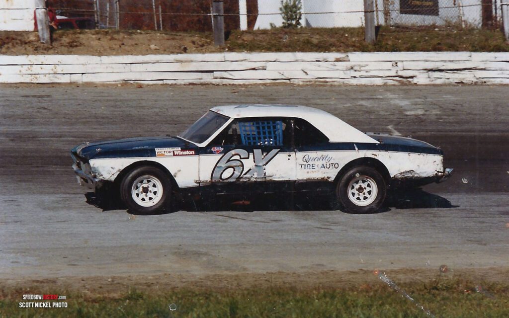 Black and white abstract pattern with concentric circles and wave shapes.