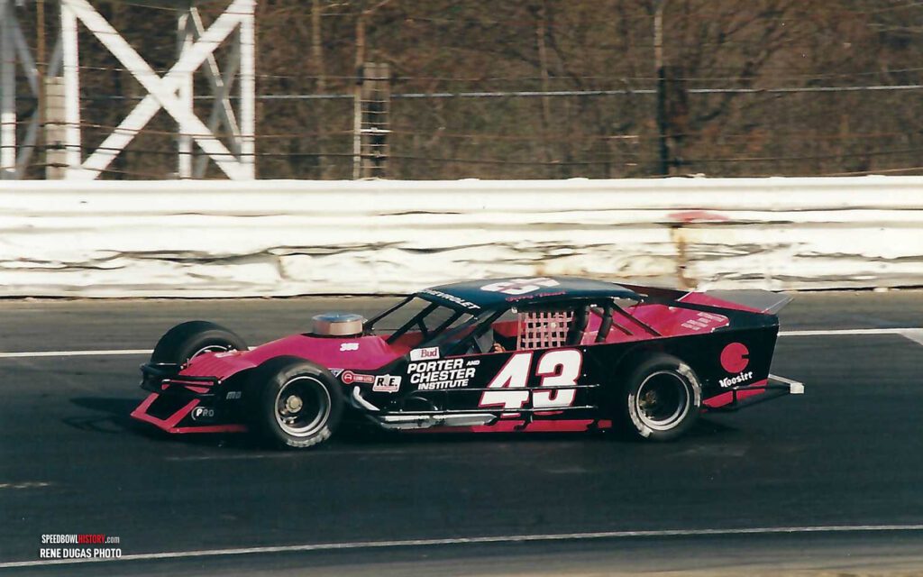 Black and white abstract pattern with concentric circles and wave shapes.