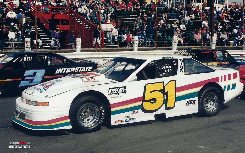 Black and white abstract pattern with concentric circles and wave shapes.