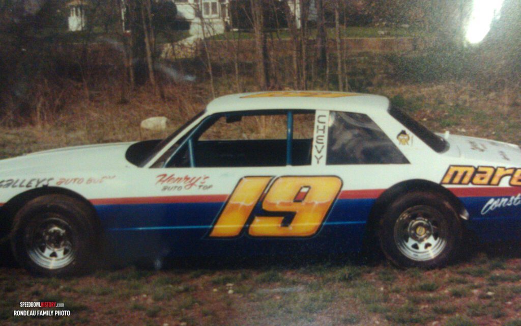 Black and white abstract pattern with concentric circles and wave shapes.