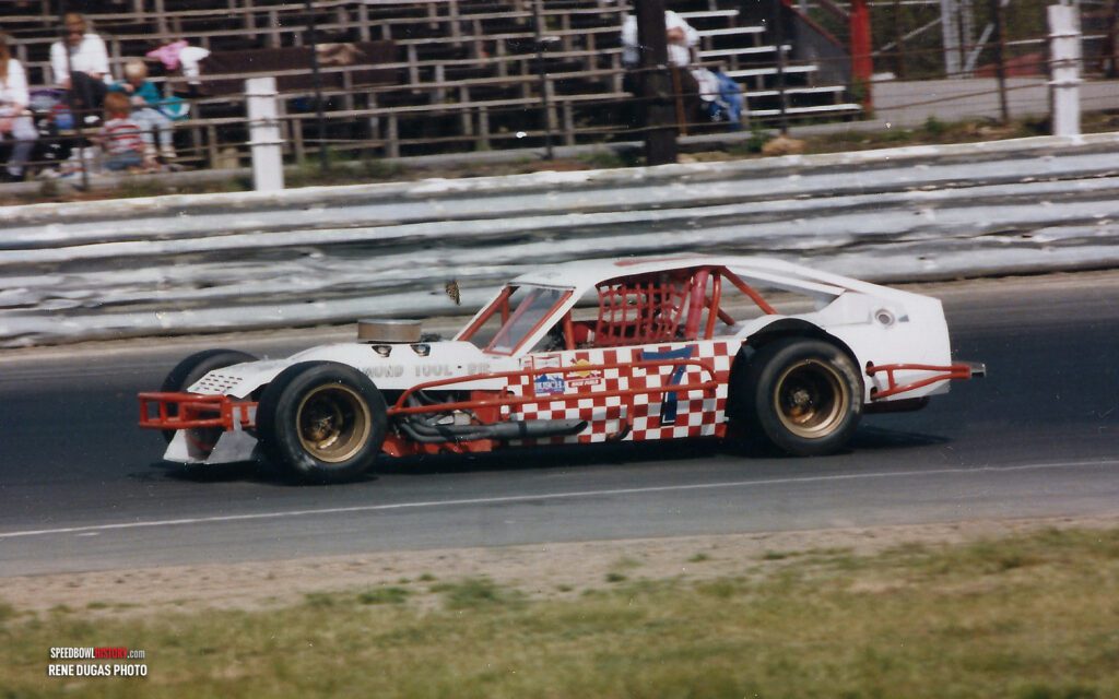 Black and white abstract pattern with concentric circles and wave shapes.