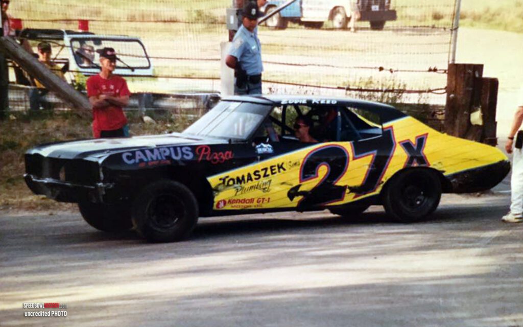 Black and white abstract pattern with concentric circles and wave shapes.