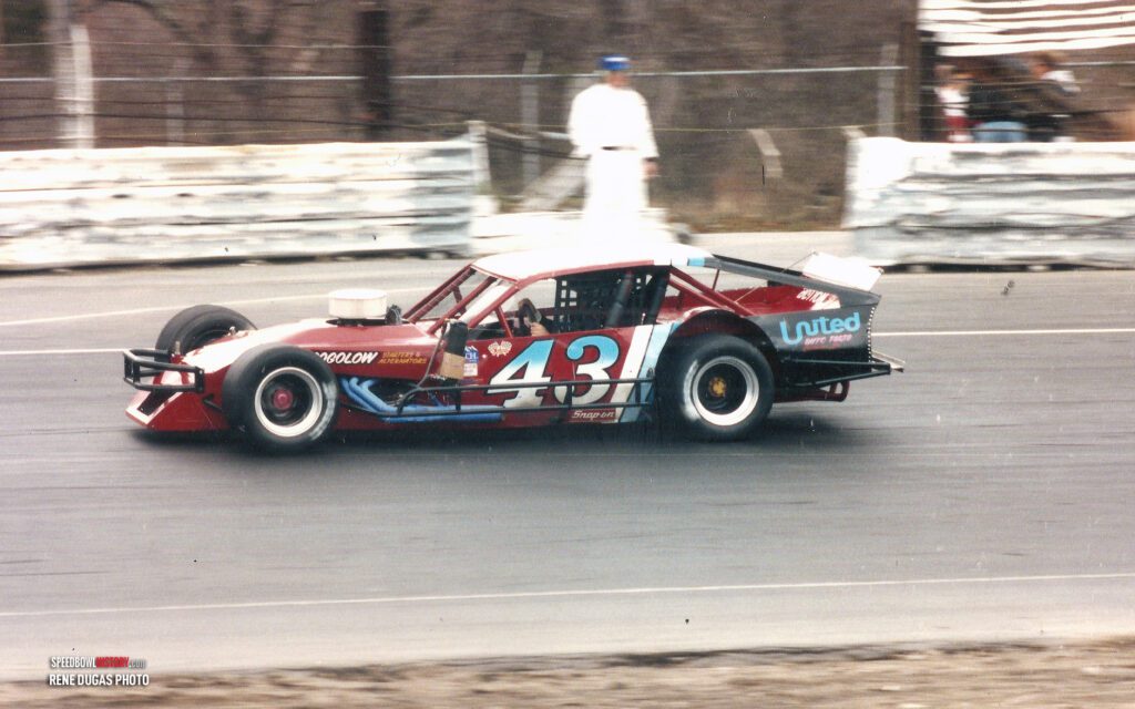 Black and white abstract pattern with concentric circles and wave shapes.