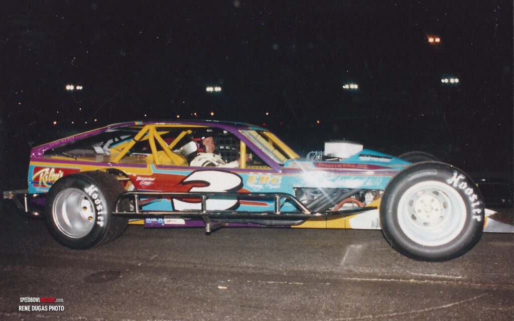 Black and white abstract pattern with concentric circles and wave shapes.