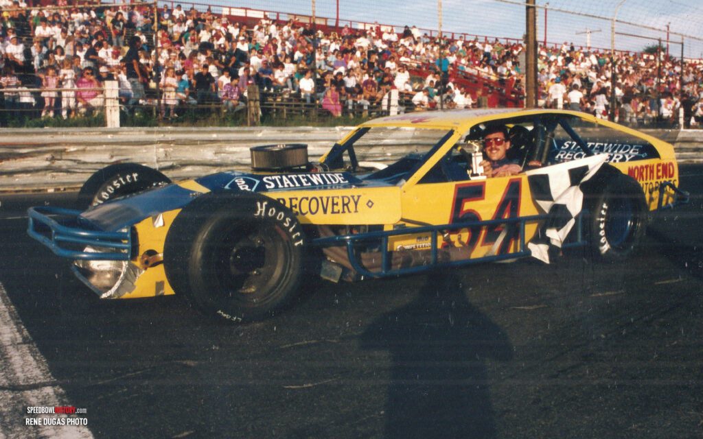 Black and white abstract pattern with concentric circles and wave shapes.