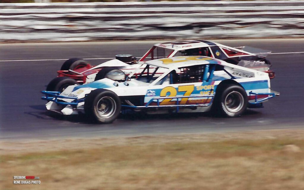 Black and white abstract pattern with concentric circles and wave shapes.