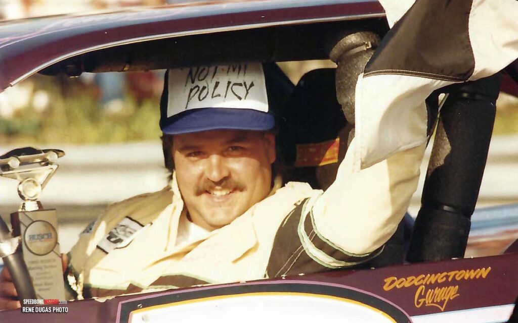 Black and white abstract pattern with concentric circles and wave shapes.