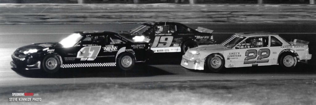 Black and white abstract pattern with concentric circles and wave shapes.