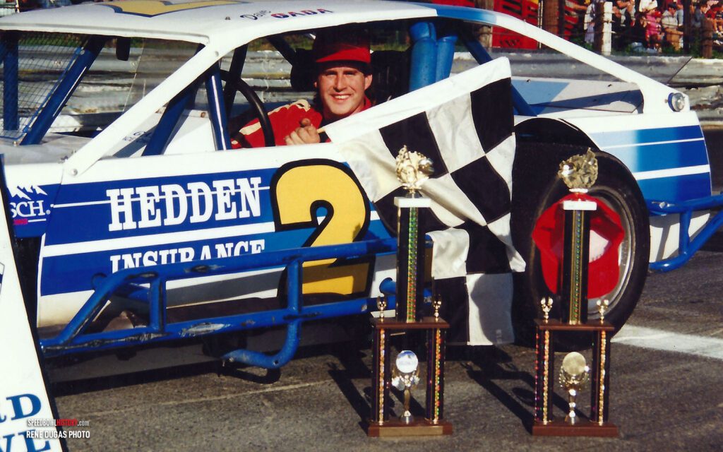 Black and white abstract pattern with concentric circles and wave shapes.