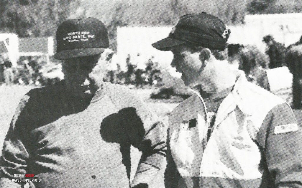 Black and white abstract pattern with concentric circles and wave shapes.