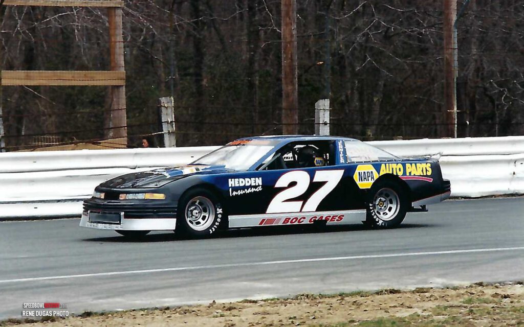 Black and white abstract pattern with concentric circles and wave shapes.