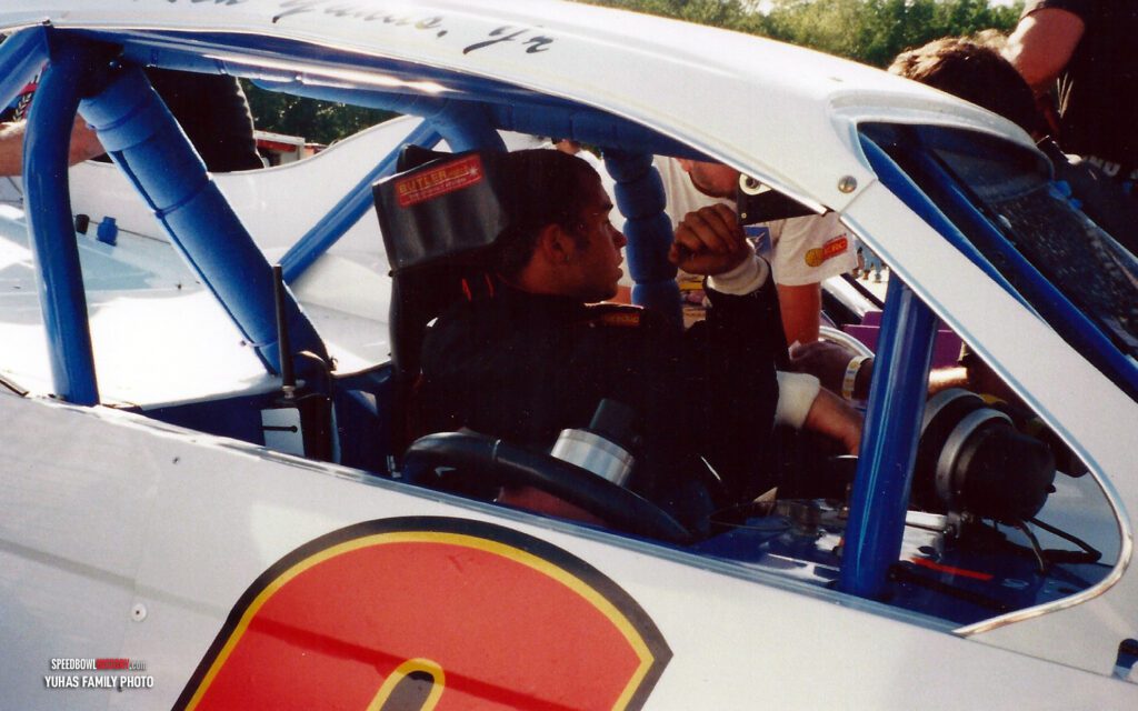 Black and white abstract pattern with concentric circles and wave shapes.